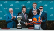 Chairman of Qatar Tourism and Chair of the Board of Directors of Visit Qatar H E Saad Bin Ali Al Kharji (second left) presenting a trophy to one of the winners.