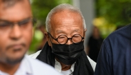 Malaysian hotel tycoon Ong Beng Seng (C) leaves the State Court in Singapore on August 4, 2025. Photo by Roslan RAHMAN / AFP