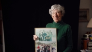 Survivor of Japanese camps during World War II and psychologist Tineke Einthoven, 87, poses with family photographs at her home in Monaco, on January 13, 2025. (Photo by Frederic Dides / AFP)
