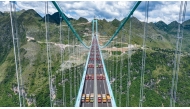 This aerial drone photo taken on August 25, 2025 shows a load test on the Huajiang Grand Canyon Bridge, set to become the world's tallest bridge, in southwest China's Guizhou Province. (Xinhua/Tao Liang)
