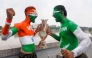 Fans with their bodies painted in national flags of India (L) and Pakistan pose in Ahmedabad on September 13, 2025, with a replica of the Asia Cup 2025 trophy on the eve of the Twenty20 international cricket match between India and Pakistan in Dubai. (Photo by Sam PANTHAKY / AFP)
