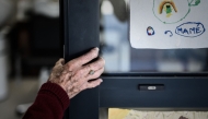 (Files) In this picture taken on September 9, 2020 an Alzheimer's patient stands at the entrance of the hairdressing salon in Dax, southwestern France. (Photo by Philippe Lopez/ AFP)