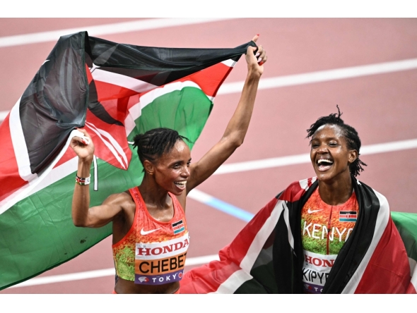 Kenya's Beatrice Chebet and Kenya's athlete Faith Kipyegon (R) celebrate after the women's 5000m final during the World Athletics Championships in Tokyo on September 20, 2025. (Photo by Philip Fong / AFP)
