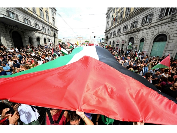 People march with a giant Palestinian flag during a nationwide strike 