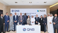 QNB and MetLife officials pose for a group photo during the signing of agreement.