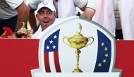 Rory McIlroy of Team Europe celebrates with the Ryder Cup after Team Europe's 15-13 win over Team United States on September 28, 2025 in Farmingdale, New York. Jared C. Tilton/Getty Images/AFP 