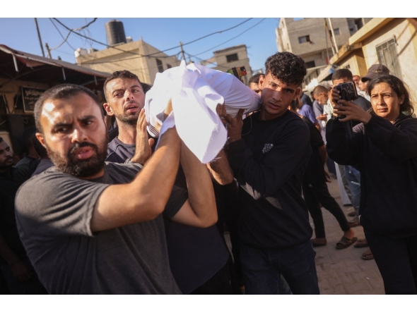 Palestinians carry the body of a man killed in an Israeli strike, during a funeral procession outside al-Aqsa Martyrs hospital in Deir el-Balah in the central Gaza Strip, on October 1, 2025. (Photo by BASHAR TALEB / AFP)
