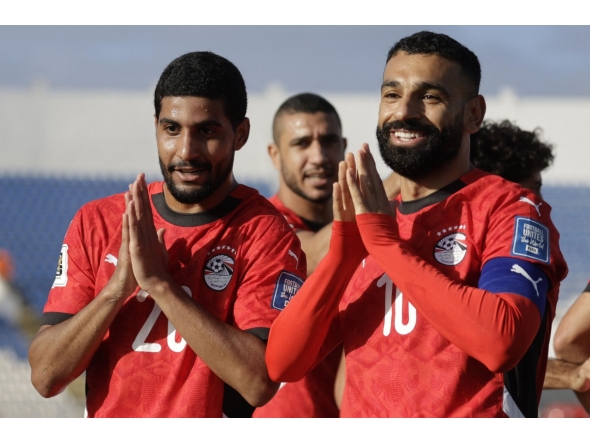 Egypt's forward #20 Ibrahim Adel celebrates with forward #10 Mohamed Salah after scoring his team's first goal during the FIFA World Cup 2026 Africa qualifier football match between Djibouti and Egypt at the Larbi Zaouli Stadium in Casablanca on October 8, 2025. (Photo by Abdel Majid BZIOUAT / AFP)
