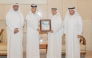 UDST President Dr. Salem Al-Naemi receiving the certificate at a ceremony.