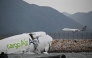 An ACT Airlines Boeing 747-400 cargo aircraft (L), wet leased by Emirates SkyCargo, is seen in the water after veering off the runway on October 20, 2025. (Photo by Peter Parks / AFP)
 