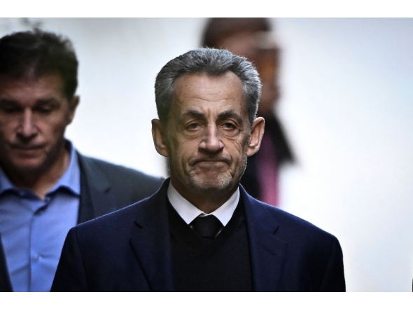 France's former president Nicolas Sarkozy leaves his residence to present himself to La Sante Prison in Paris, on October 21, 2025. Photo by julien de rosa / AFP