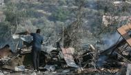 A man stands amid the debris at the site of an Israeli airstrike in the southern Lebanese village of Toura on November 6, 2025. (Photo by MAHMOUD ZAYYAT / AFP)
