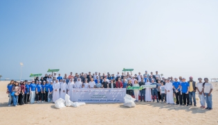 UDST President Dr. Salem Al-Naemi with staff and students during the beach cleanup initiative at Al Wakrah Public Beach.