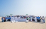 UDST President Dr. Salem Al-Naemi with staff and students during the beach cleanup initiative at Al Wakrah Public Beach.