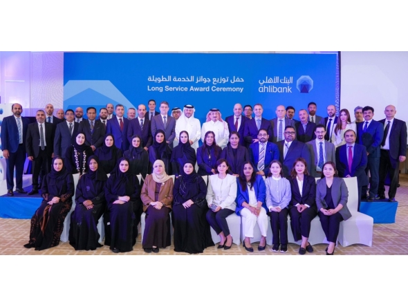 Ahlibank officials with its long-serving employees at the award ceremony.