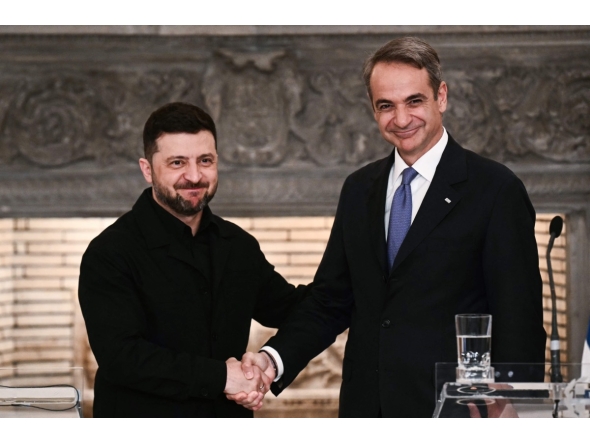 Greece's Prime Minister Kyriakos Mitsotakis (R) and Ukraine's President Volodymyr Zelensky shake hands after attending a joint press conference following their meeting in Athens, on November 16, 2025. Photo by Angelos Tzortzinis / AFP