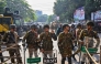 Security personnel stand guard as demonstrators attempt to demolish the residence of Sheikh Mujibur Rahman in Dhaka on November 17, 2025. (Photo by Munir Uz Zaman / AFP)
