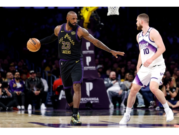LeBron James #23 of the Los Angeles Lakers dribbles the ball against Svi Mykhailiuk #10 of the Utah Jazz during the second half on November 18, 2025 in Los Angeles, California. Ronald Martinez/Getty Images/AFP 