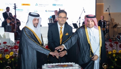 Minister of Public Health, H E Mansoor bin Ebrahim bin Saad Al Mahmoud; Director of the Protocol Department at MoFA, H E Ibrahim Yousif Abdullah Fakhro; and Ambassador of Germany to Qatar H E Oliver Owcza cutting the cake to celebrate  the Day of German Unity. 
