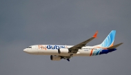 A Flydubai Boeing 737 MAX 8 performs a display flight at Al-Maktoum International Airport during the Dubai Airshow 2025 in Dubai on November 17, 2025. (Photo by Giuseppe CACACE / AFP)