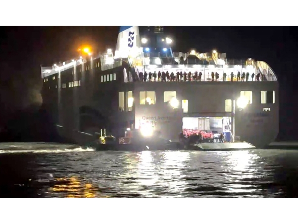 This handout photo taken on November 19, 2025 and released by the Mokpo Coast Guard via Yonhap shows the Coast Guard conducting rescue operations for passengers of the grounded ferry near Jangsan Island in Sinan County. Photo by Mokpo Coast Guard / AFP