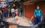 A police personnel stands guard near the rubble that fell from a damaged building following an earthquake in Old Dhaka on November 21, 2025. (Photo by Munir UZ ZAMAN / AFP)