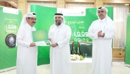 Undersecretary of the Ministry of Awqaf and Islamic Affairs H E Dr. Sheikh Khalid bin Mohammed bin Ghanem Al Thani honouring a winner at the ceremony.