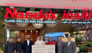 Nando’s representatives handing over the cheque to QCS representatives, who in turn presented a trophy to the Nando’s team.