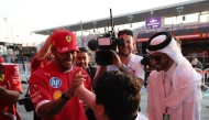 Ferrari's British driver Lewis Hamilton is greeted by a fan.
