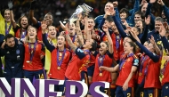 Spain’s players celebrate with the trophy. 