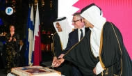 Minister of Labour H E Dr. Ali bin Smaikh Al Marri; Minister of Transport H E Sheikh Mohammed bin Abdullah bin Mohammed Al-Thani; and Ambassador of Finland to Qatar H E Juha Mustonen cut a cake to mark the occasion at an event in Doha yesterday. Pic: Mohamed Al Attar/ The Peninsula