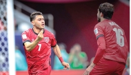 Jordan's Mohammad Abu Zraiq (left) celebrates after scoring a goal.