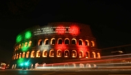 The Colosseum is illuminated and a message reads 