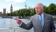 (Files) Britain's King Charles III gestures as he travels aboard the hybrid vessel 'Mars Clipper' on the River Thames on May 7, 2025. (Photo by Toby Melville / Pool / AFP)
 