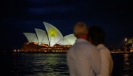 The Sydney Opera House is illuminated with candlelights in Sydney on December 21, 2025, as part of a national day of reflection honouring the victims of the Bondi Beach terrorist attack. (Photo by George Chan / AFP)