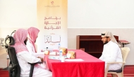 Ministry of Awqaf officials with a participant during the Asaneed programme session.