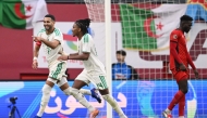 Algeria's forward #7 Riyad Mahrez (L) celebrates scoring the team's second goal with Algeria's midfielder #14 Hicham Boudaoui during the Africa Cup of Nations (CAN) Group E football match between Algeria and Sudan at Moulay Hassan Stadium in Rabat on December 24, 2025. (Photo by SEBASTIEN BOZON / AFP)

