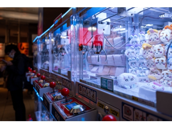 In this picture taken on November 22, 2025, stuffed toys are seen inside claw crane game machines inside a shop at Tokyo's Shinjuku district. (Photo by Philip Fong / AFP) 