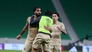 Al Rayyan's Mohammed Saleh (left) celebrates with teammates after scoring the late equaliser.
