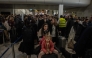 Passengers queue and wait with luggage at a departure hall of Athens' Eleftherios Venizelos international airport in Spata near Athens, on January 4, 2025.  (Photo by Angelos TZORTZINIS / AFP)