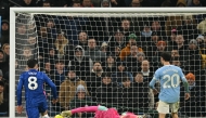 Manchester City's Italian goalkeeper #25 Gianluigi Donnarumma makes a save as Chelsea's Argentinian midfielder #08 Enzo Fernandez prepares to score during the English Premier League football match between Manchester City and Chelsea at the Etihad Stadium in Manchester, north west England, on January 4, 2026. (Photo by Oli SCARFF / AFP)