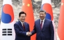 South Korea's President Lee Jae Myung (L) shakes hands with China's President Xi Jinping (R) during a Memorandum of Understanding (MOU) signing ceremony at the Great Hall of the People in Beijing on January 5, 2026. Photo by YONHAP / AFP