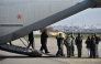 The coffins of four Italian nationals killed in the New Year's fire disaster at Le Constellation in the Alpine ski resort town of Crans-Montana in Switzerland, are carried on the tarmac after the landing of Italian Air Force C130 at Linate Milan airport on January 5, 2026. Photo by MATTEO CORNER / ANSA / AFP