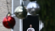 Pope Leo XIV delivers a speech to pilgrims from the window of the apostolic palace overlooking St. Peter's square during his Sunday Angelus prayer at the Vatican on January 4, 2026. (Photo by Filippo MONTEFORTE / AFP)