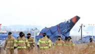 Firefighters take part in a search operation near the site where a Jeju Air Boeing 737-800 aircraft crashed and burst into flames at Muan International Airport in Muan, some 288 kilometres southwest of Seoul on January 11, 2025. Photo by YONHAP / AFP

