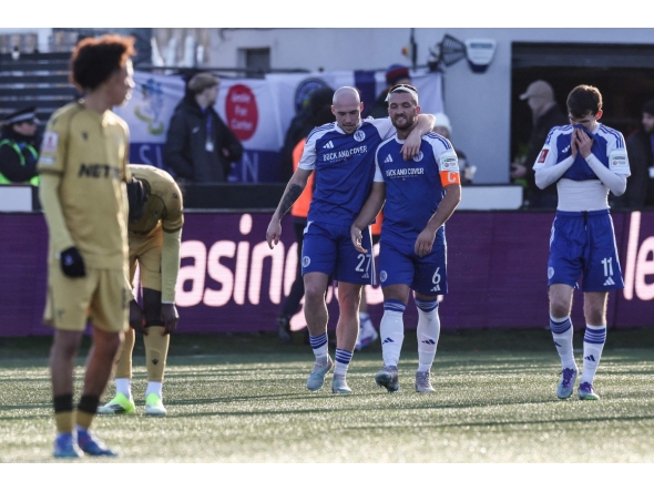 Macclesfield's English midfielder #27 Josh Kay (centre L) walks back with Macclesfield's English midfielder #06 Paul Dawson (centre R) after the latter scored the team's first goal during the English FA Cup third round football match between Macclesfield Town and Crystal Palace at Leasing.com Stadium, Moss Rose in Macclesfield, northern England on January 10, 2026. (Photo by Darren Staples / AFP) 