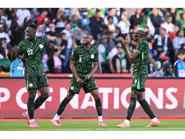 Nigeria's forward #22 Akor Adams and Nigeria's midfielder #08 Frank Onyeka celebrate Nigeria's forward #09 Victor Osimhen 's goal during the Africa Cup of Nations (CAN) quarter-final football match between Algeria and Nigeria at the Grand stadium in Marrakesh on January 10, 2026. (Photo by SEBASTIEN BOZON / AFP)

