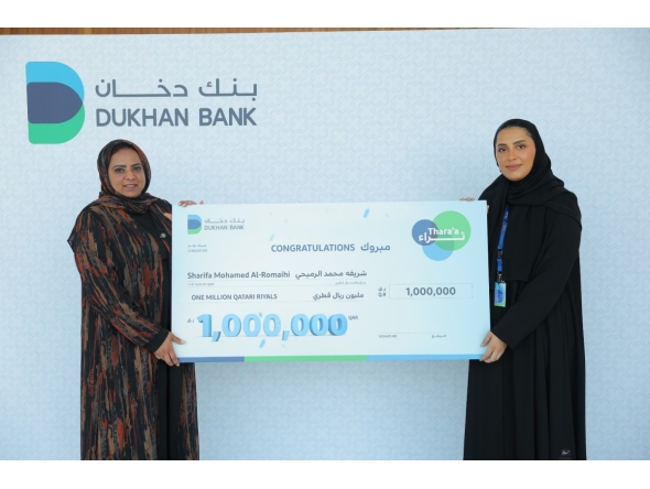 A Dukhan Bank official presenting the grand prize to the winner.