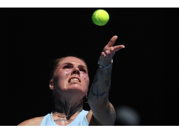 Ukraine's Oleksandra Oliynykova serves to USA's Madison Keys during their women's singles match on day three of the Australian Open tennis tournament in Melbourne on January 20, 2026. (Photo by Martin Keep / AFP) 