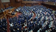 Lawmakers cheer as the House of Representatives is dissolved at the Diet in Tokyo on January 23, 2026. Photo by JIJI Press / AFP